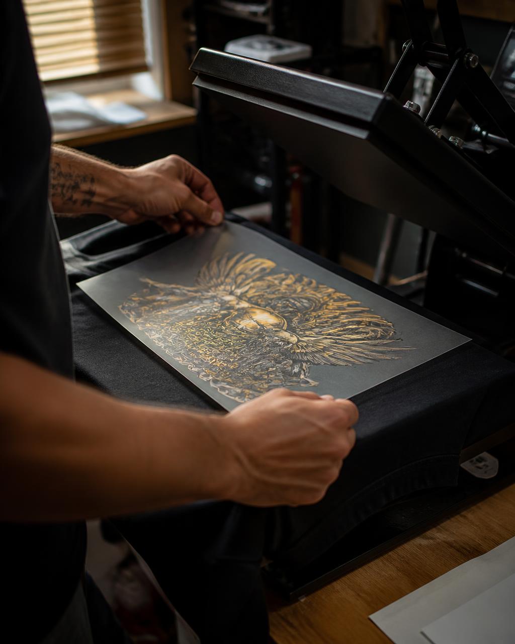 Hands pressing a custom DTF transfer onto a shirt at Hernandez Family Customz